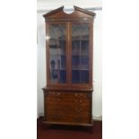 A 19th century mahogany bookcase, the upper section with open pediment, two astrical glaze door