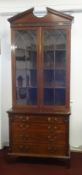 A 19th century mahogany bookcase, the upper section with open pediment, two astrical glaze door