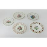 Five porcelain cabinet plates decorated with flowers and fruits.
