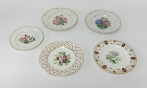 Five porcelain cabinet plates decorated with flowers and fruits.