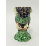 A Majolica pottery vase decorated with lion masks and green ferns, height 15cm.