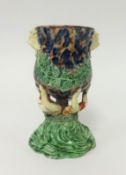 A Majolica pottery vase decorated with lion masks and green ferns, height 15cm.