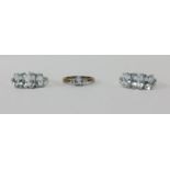 A 9ct diamond solitaire ring together with two silver three stone dress rings (3).