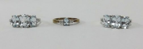 A 9ct diamond solitaire ring together with two silver three stone dress rings (3).