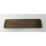 Newlyn, a small copper tray embossed with three fish, marked 'Newlyn', 26cm x 7cm.