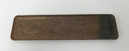 Newlyn, a small copper tray embossed with three fish, marked 'Newlyn', 26cm x 7cm.