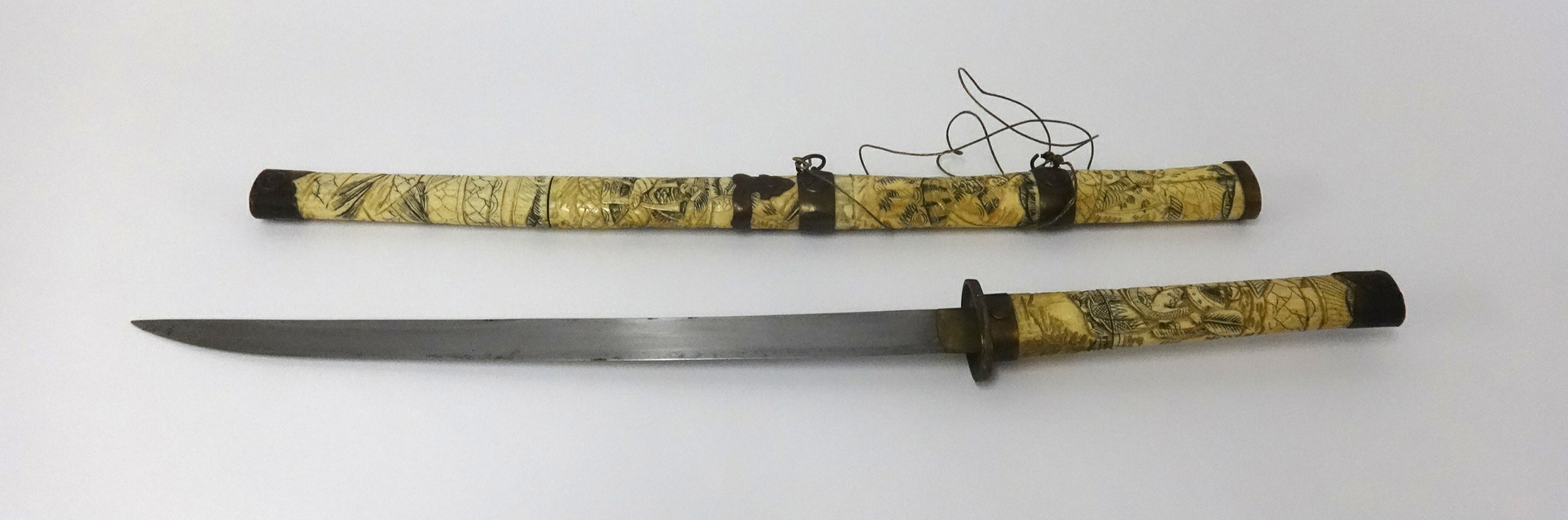 A Japanese? Short sword with carved bone and metal mounted scabbard and handle decorated with - Image 2 of 2