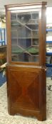 A Georgian mahogany and inlaid two part free standing corner cabinet.