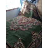 Persian style rug on green ground, width 168cm, length 220 cm.