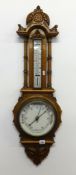 A early 20th century carved oak wall barometer thermometer.