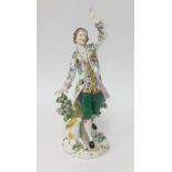 A porcelain figure of a gentleman in period costume with a floral jacket (gold anchor mark to