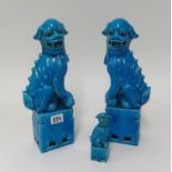 A pair of Chinese foo dogs, height 32cm and a smaller one.