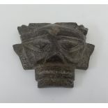 An aztec style face mask in stone, height 16cm.