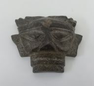 An aztec style face mask in stone, height 16cm.