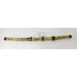 A Japanese? Short sword with carved bone and metal mounted scabbard and handle decorated with