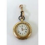 A small antique 14ct gold fob watch with keyless movement and enamelled dial.