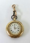 A small antique 14ct gold fob watch with keyless movement and enamelled dial.