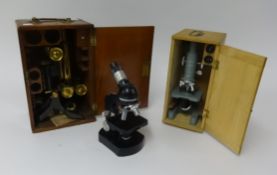 A 1950's brass microscope with mahogany box together with two other microscopes (3).