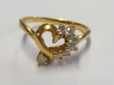 A gold heart and diamond ring, size G.