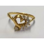 A gold heart and diamond ring, size G.