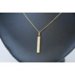 An 18ct diamond pendant and gold chain.