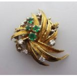 An 18ct spray brooch set with six diamonds and four emeralds, 8.2gms.