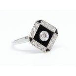 A ladies platinum and diamond black onyx square dress ring comprising a single old cut diamond