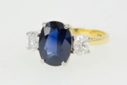 A good 18ct sapphire and diamond three stone ring, size N.