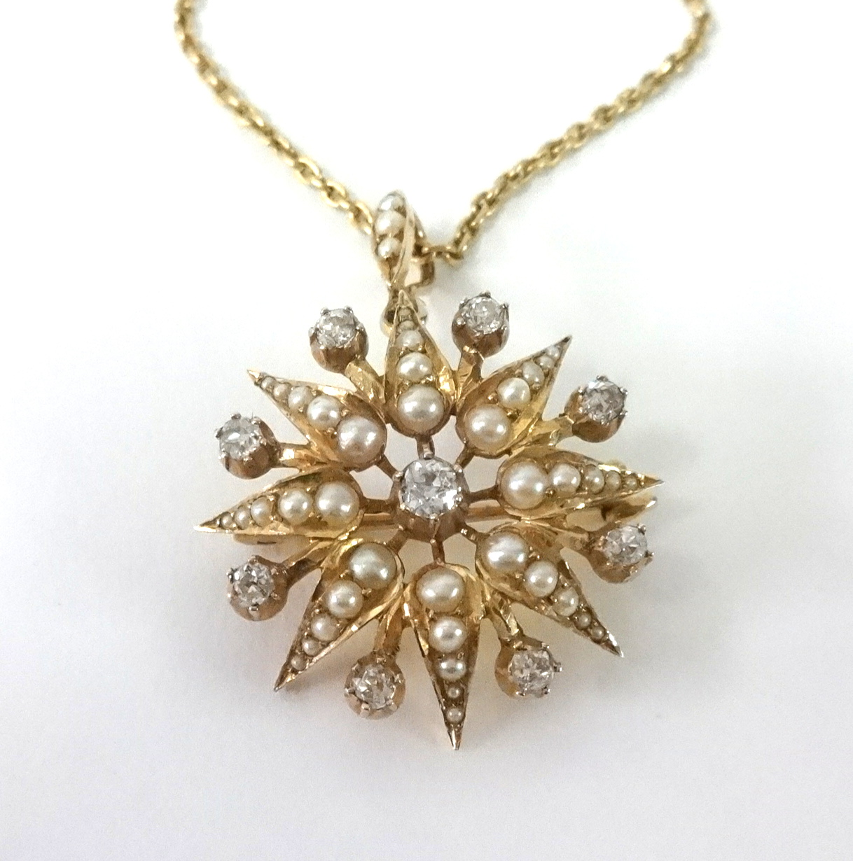 An antique diamond and pearl star pendant set in yellow gold, diameter 26mm. - Image 2 of 2