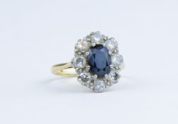 An 18ct sapphire and diamond cluster ring, size L/M.