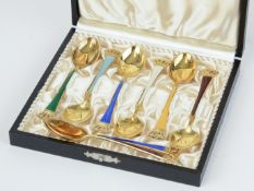 A eight piece silver enamel and gilt tea spoon set, marked 'Denmark, Stirling'.