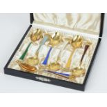 A eight piece silver enamel and gilt tea spoon set, marked 'Denmark, Stirling'.