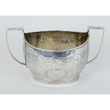 A Geo V sugar bowl with handles and incised decoration, approx 4.64oz.