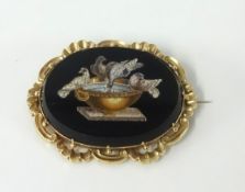 An antique gold and micro mosaic brooch depicting birds on a bird bath.