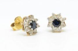 A pair of sapphire and diamond cluster earrings.