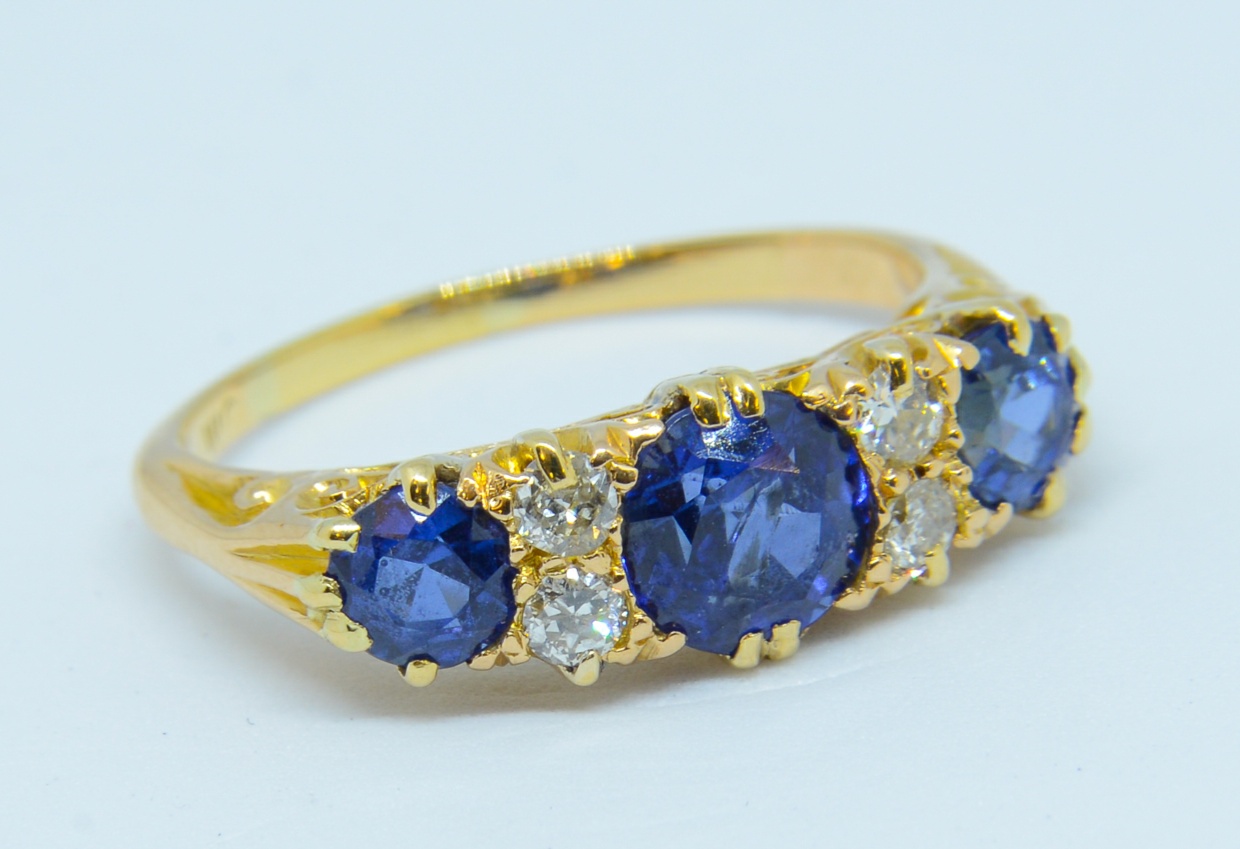 A sapphire and diamond ring set in yellow gold, unmarked, size K.