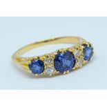 A sapphire and diamond ring set in yellow gold, unmarked, size K.