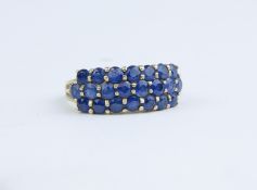 A 14k three row sapphire set dress ring, size N.