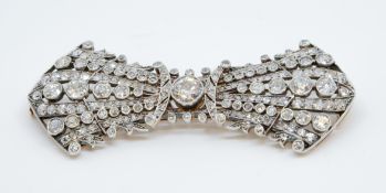 An antique gold and silver set diamond bow brooch consisting of 185 old cut and rose cut diamonds,