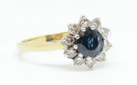 An 18ct sapphire and diamond cluster ring, with insurance valuation dated 1986, size S.