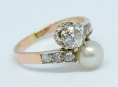 A diamond and pearl cross over ring, set with six central diamonds and six further old cut