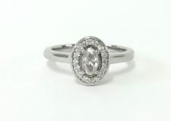 A ladies diamond cluster ring set platinum, with insurance valuation dated 2019 at £1,650, size K.