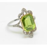 An antique peridot and diamond ring set in platinum and yellow gold, the octagonal old cut peridot