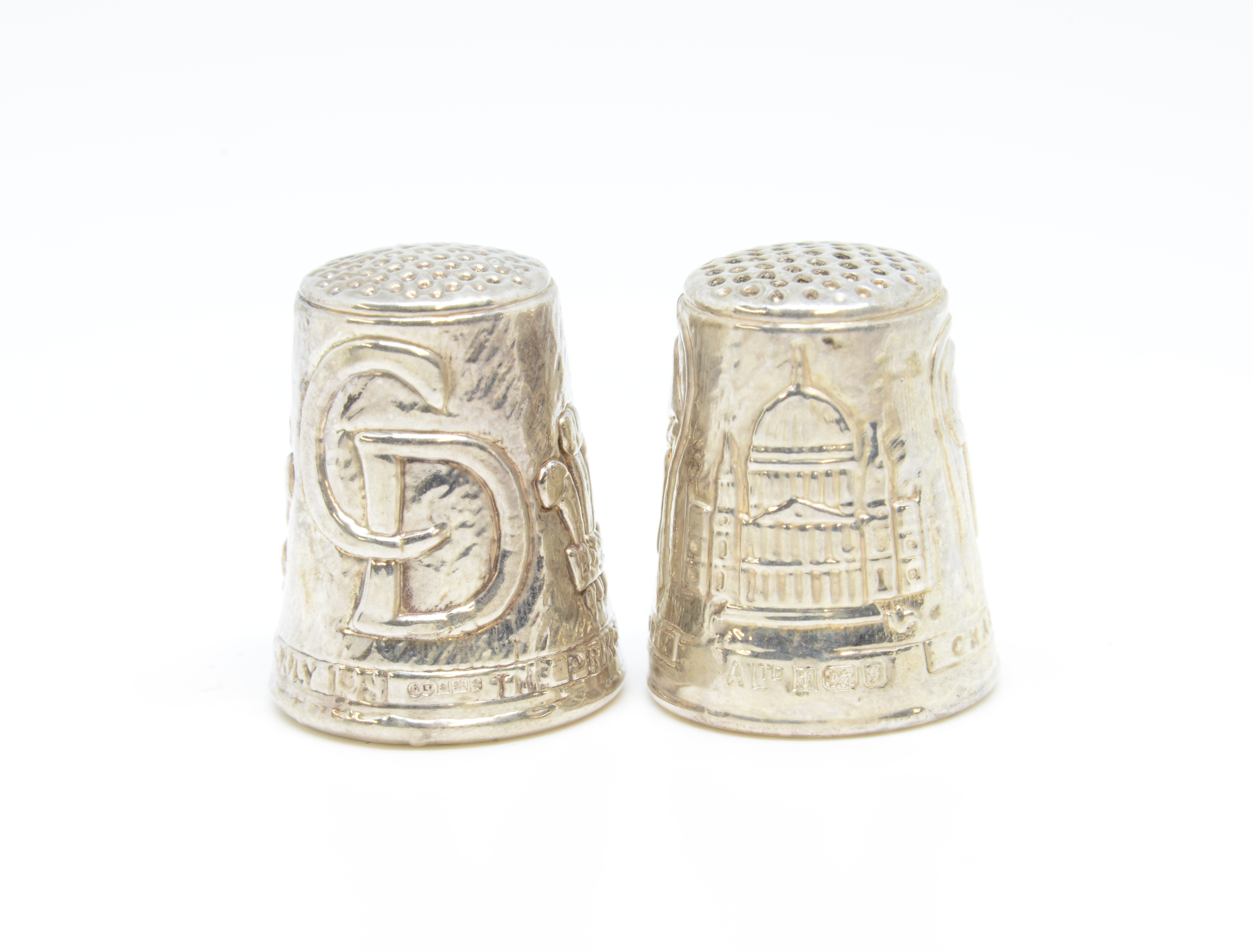 A pair of modern silver 'The Heritage Collection' thimbles.