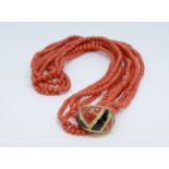 A coral five strand necklace with an 18ct diamond end clasp of art deco design.