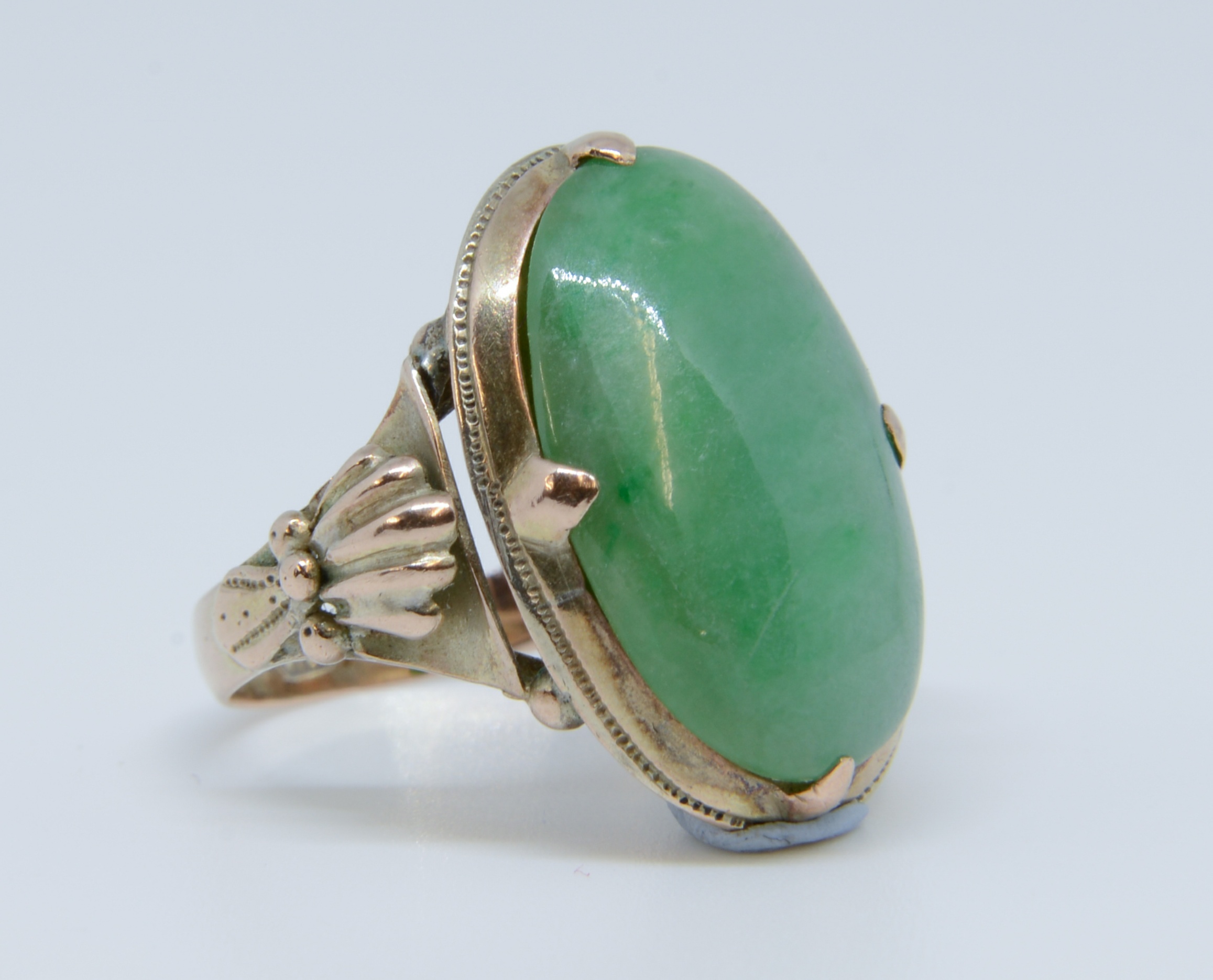 An antique jade set yellow gold ring marked '14k', size J, stone size approx 20mm x 10mm.