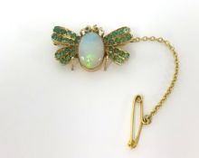 A opal and emerald bug brooch.
