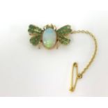 A opal and emerald bug brooch.