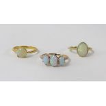 Three opal set rings including 18ct.