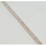 An 18ct diamond line bracelet, total diamond weight approx 2.80cts, length 18cm.